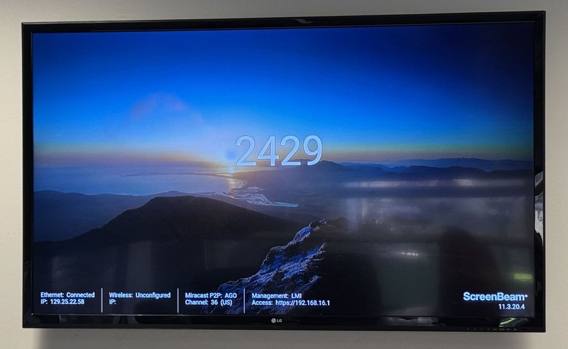 Display in Speitel conference room showing the pin code to connect to the wireless receiver
